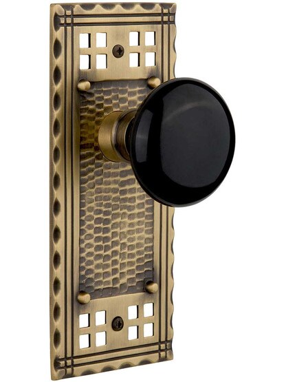 Pasadena Door Set with Black Porcelain Knobs in Antique Brass.